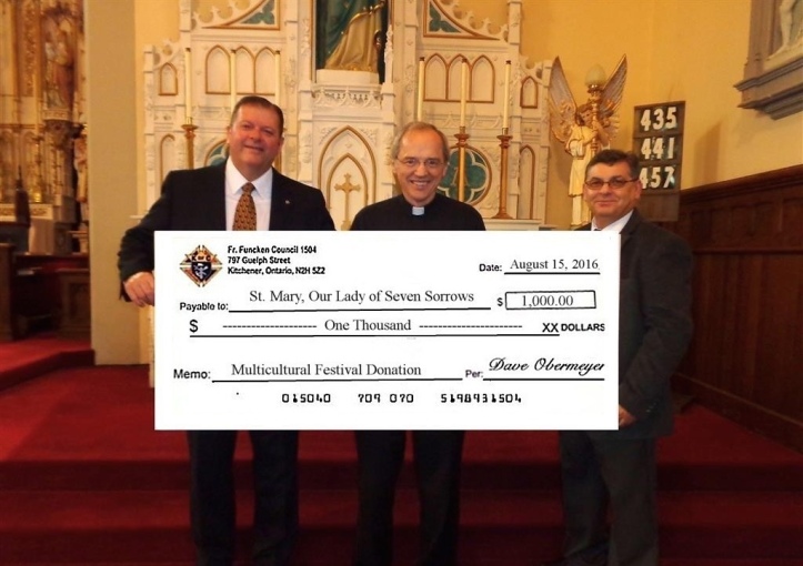 GK Dave Obermeyer and DGK Mike Szabo present a cheque for $1000.00 to Father George Nowak.